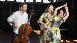 Leigh Sales and Annabel Crabb, with Australian Chamber Orchestra cellist Julian Thompson and baritone cello (nicknamed Barry) at the ACO’s harbourside headquarters in Walsh Bay, Sydney.