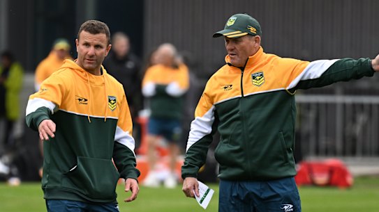 Assistant coach Willie Peters plans out training with head coach Kevin Walters.