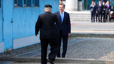South Korean President Moon Jae-in, right, and North Korean leader Kim Jong-un meet at their country's exact border in the truce village of Panmunjom in the DMZ in April.