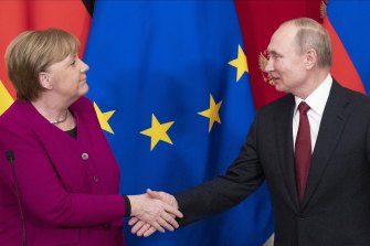 German Chancellor Angela Merkel and Russian President Vladimir Putin shake hands after a meeting last year. 
