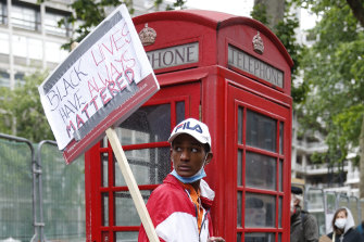 Protesters hold placards as they march through central London.