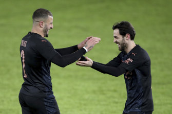 Kyle Walker and Bernardo Silva celebrate during City’s record-breaking victory.