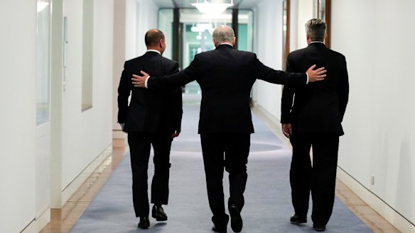 Treasurer Josh Frydenberg, Prime Minister Scott Morrison and Minister for Finance Mathias Cormann leave the press conference held after passing the government's tax cuts.