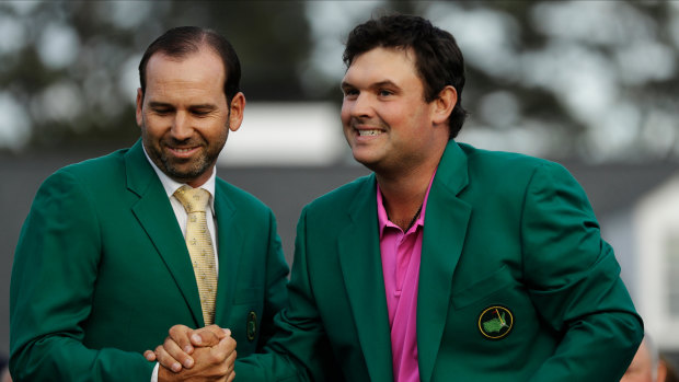 Good fit: Reed receives his green jacket from Sergio Garcia last year.