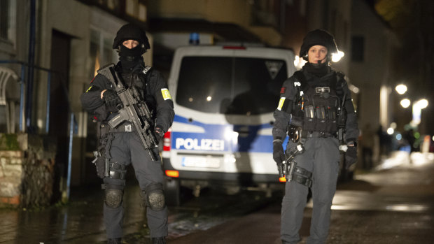 Armed police are seen at the site of a car crash during a carnival procession in Volkmarsen, Germany.