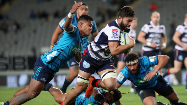 Caught short: Melbourne Rebels’ Colby Faing’a is tackled during the clash with the Blues at Eden Park.