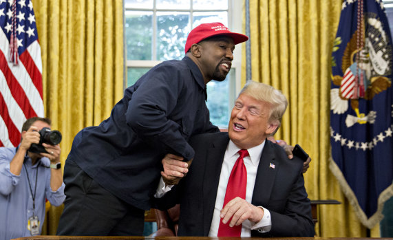 West shakes hands with Trump during a meeting in the Oval Office in 2018.