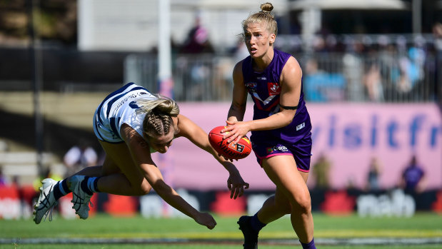 Committed: Fremantle's Jasmin Stewart evades a flying tackle.