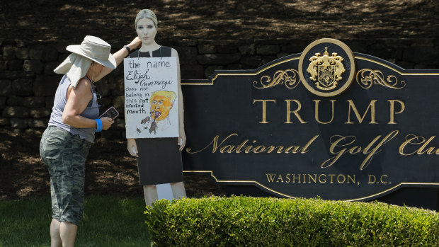 A woman places a cutout picture of Ivanka Trump outside the Trump National Golf Club in Sterling, Virginia, to protest against her father's comments on Elijah Cummings.