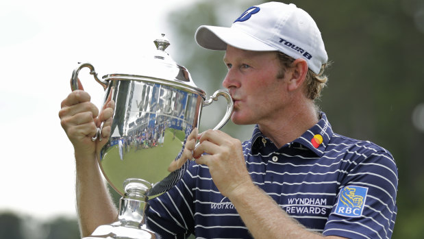 Comfortable: Brandt Snedeker kisses the trophy after winning the Wyndham Championship for a second time.