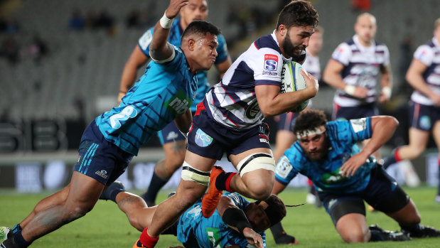 Caught short: Melbourne Rebels’ Colby Faing’a is tackled during the clash with the Blues at Eden Park.
