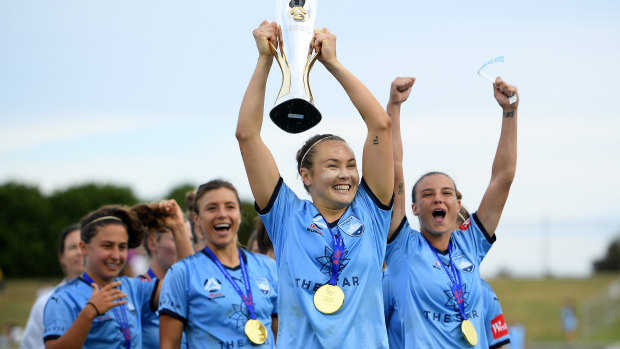 Jubilant: Caitlin Foord of Sydney holds the trophy aloft.