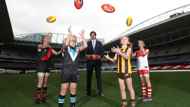 Gillon Mclachlan poses with young footballers Nora Don, Fadilla Taleb, Leni Burgoyne and Layla Rabah.