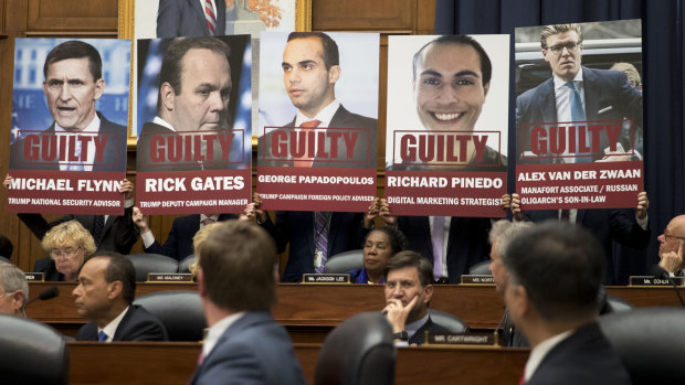 Posters of people who have pleaded guilty in Robert Mueller's probe are shown during a joint House committee hearing in Washington.