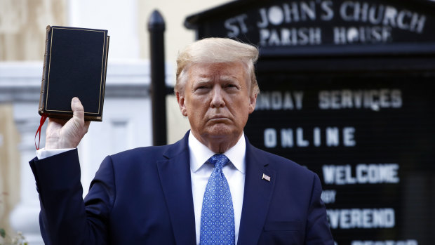 Donald Trump holding up a bible outside a church damaged during Black Lives Matter protests in Washington DC.