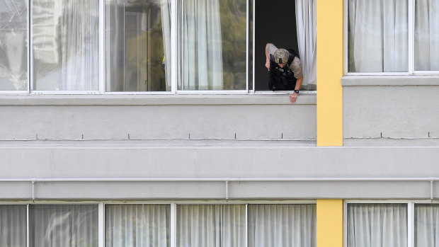 A police SERT office at the Chasely Apartments Hotel, where two armed people were holed up in an apartment below. 