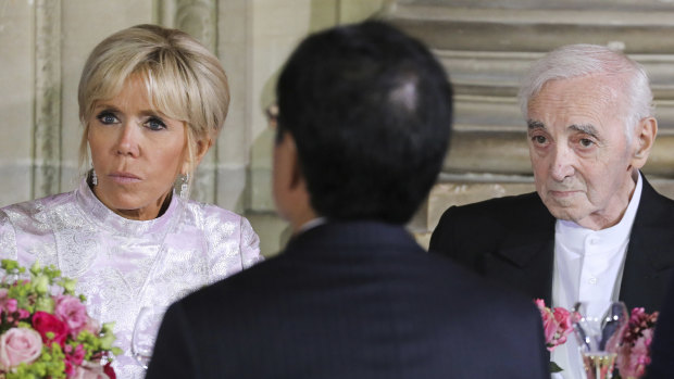 Sept. 12, 2018 French President's wife Brigitte Macron and French singer Charles Aznavour listen to speeches during an official state dinner with Japan's Crown Prince Naruhito at the Chateau de Versailles.