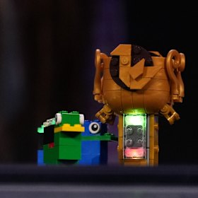 A Lego piece with a smart brick attached.