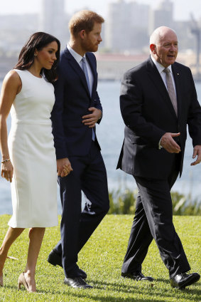Britain's Prince Harry and Meghan, Duchess of Sussex, walk the lawns of Admiralty House with Australia's Governor-General Sir Peter Cosgrove.