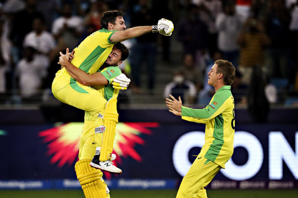 Mitch Marsh celebrates the 2021 T20 World Cup victory with Marcus Stoinis and Adam Zampa. 