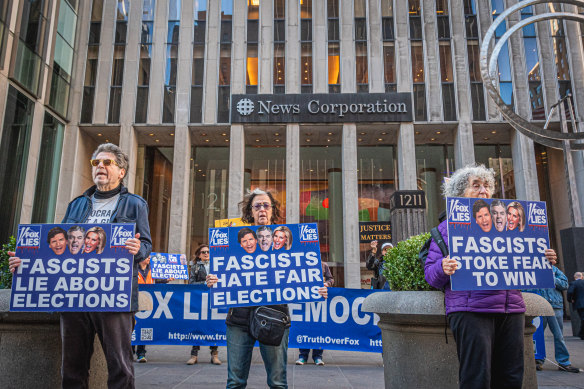 Members of the activist groups Truth Tuesdays and Rise and Resist gather at the weekly Fox Lies Democracy Dies event outside the News Corporation building in New York.