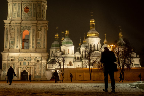 People walk past Saint Sophia Cathedral at Sophia Square in Kyiv, Ukraine. 