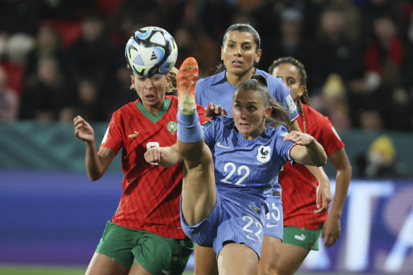 Eve Perisset hooks the ball clear against Morocco.