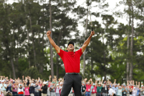 Tiger Woods celebrates after sinking his putt on the 18th green to win during the final round of the Masters in 2019.