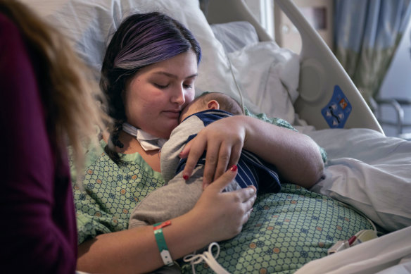 Macenzee Keller, 20, clutches her two-month-old son Zachery for the first time since giving birth.