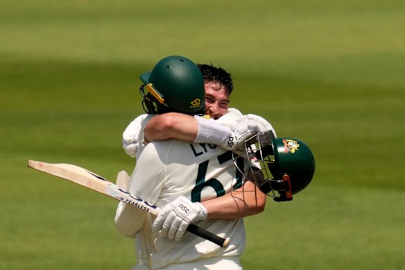 Australia’s Matt Renshaw celebrates his century with his teammate Nathan Lyon on day two.