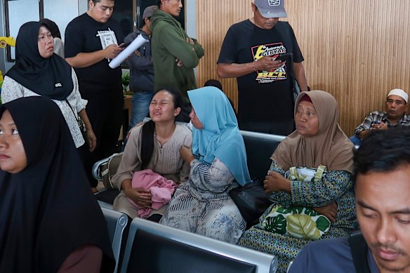 Relatives of passengers onboard a ferry that sank off Bali despair in East Java.