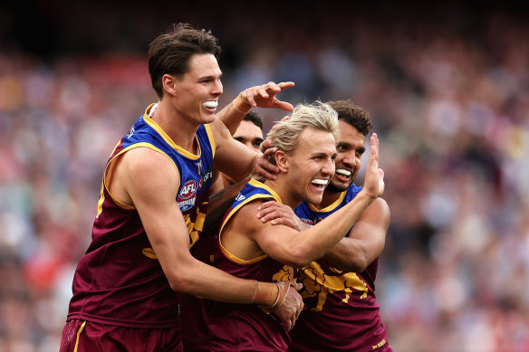Kai Lohmann of the Lions celebrates kicking a goal.