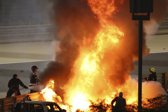 Marshals extinguish flames after Romain Grosjean's horror crash in Bahrain.