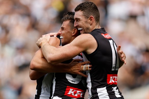 Happy days: Nick Daicos and Dan McStay celebrate a goal, as the Magpies remain unbeaten to start the new season.