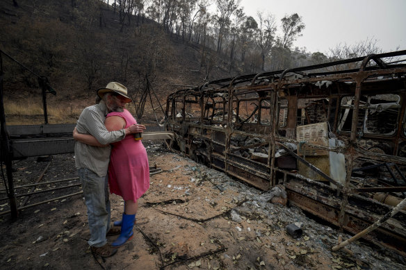 Mark Brooks hugs his daughter Kylee after losing his home in the fires.