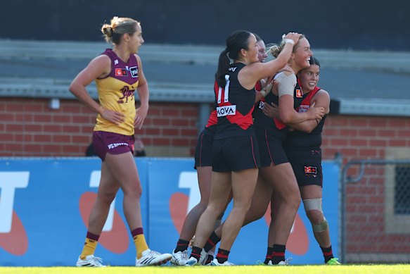 The Bombers celebrate a goal with Emily Gough.