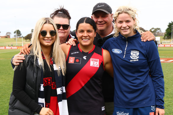 Madison Prespakis of the Bombers and Georgie Prespakis of the Cats pose with family members after the game.