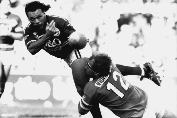 Cliff Lyons gets an offload away for Manly against Canberra in 1991, one year after he won the Dally M.