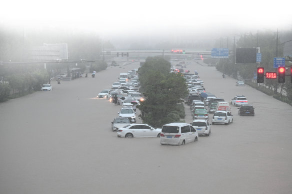 Vehicles are stranded in floodwater near Zhengzhou railway station, China, 2021. 