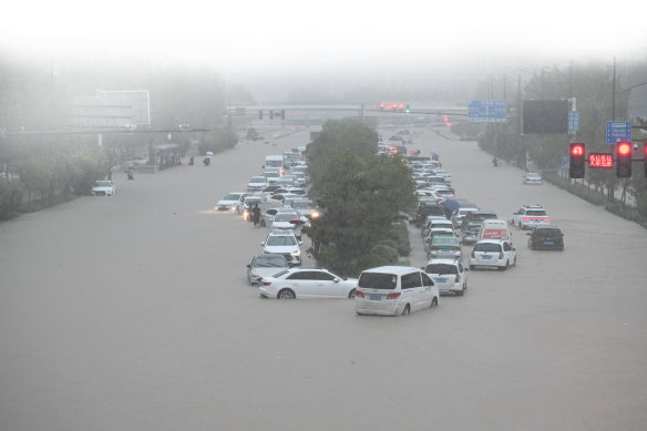 Flooding has contributed to the disruptions. Vehicles are stranded in floodwater near Zhengzhou Railway Station on July 20.