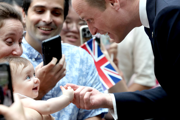 Prince William greeting members of the public at Singapore’s Changi airport yesterday.