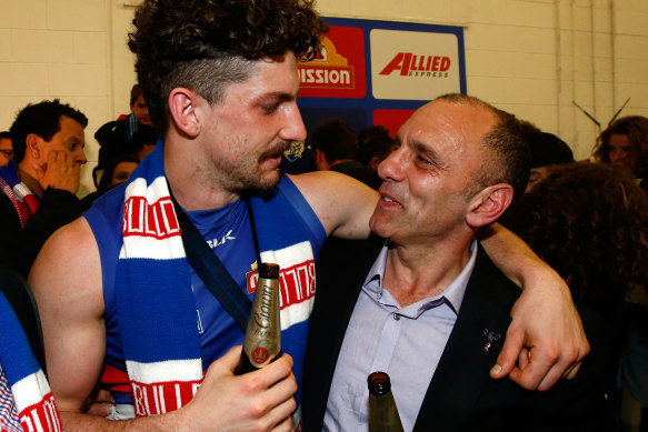 Father and son share a moment after the 2016 premiership.