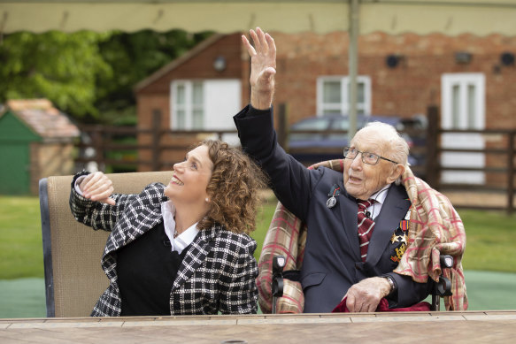 Colonel Tom Moore and his daughter Hannah Ingram-Moore watch a flypast over his home to celebrate his 100th birthday on April 30, 2020.