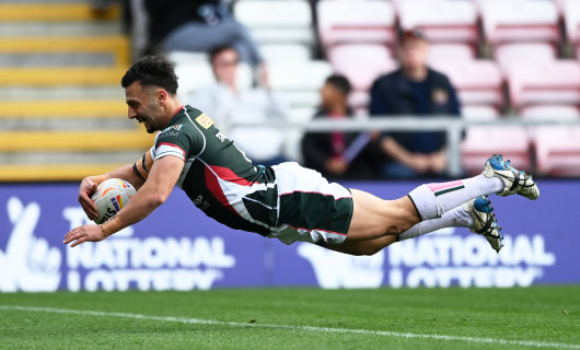 Lebanon’s Michael Tannous swan dives over for a try against Jamaica.