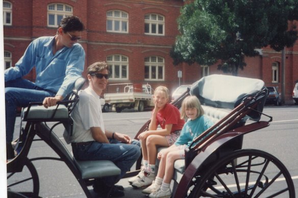 The writer (centre) with her sister, Belinda, and stepfather Ross.
