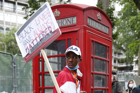 Protesters hold placards as they march through central London.