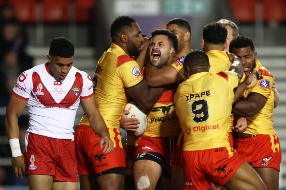 Papua New Guinea players celebrate during their game against Tonga at the World Cup.