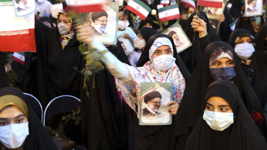 Supporters of Iranian president-elect Ebrahim Raisi celebrate after his presidential election win. 