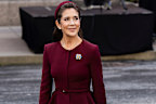 Queen Mary wore a new burgundy suit by French designer Roland Mouret and a hat by Danish milliner Katrin Cecilia Jacobsen.