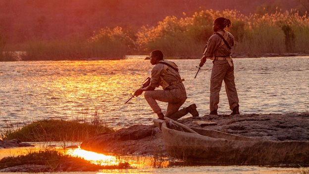 Members of the Amaganyane anti-poaching unit keep watch over the Zambezi River. 